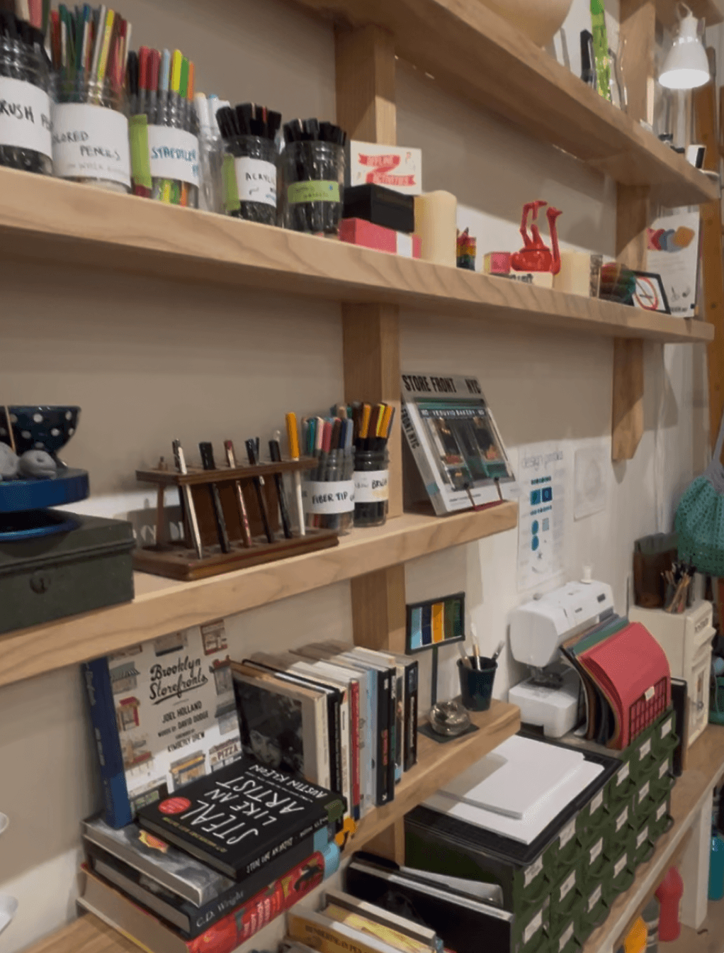 Creative studio shelves with art supplies and books